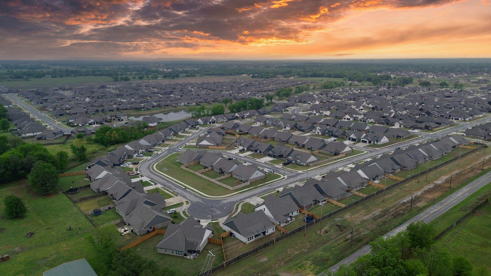 Aerial view of a residential neighborhood at sunset.