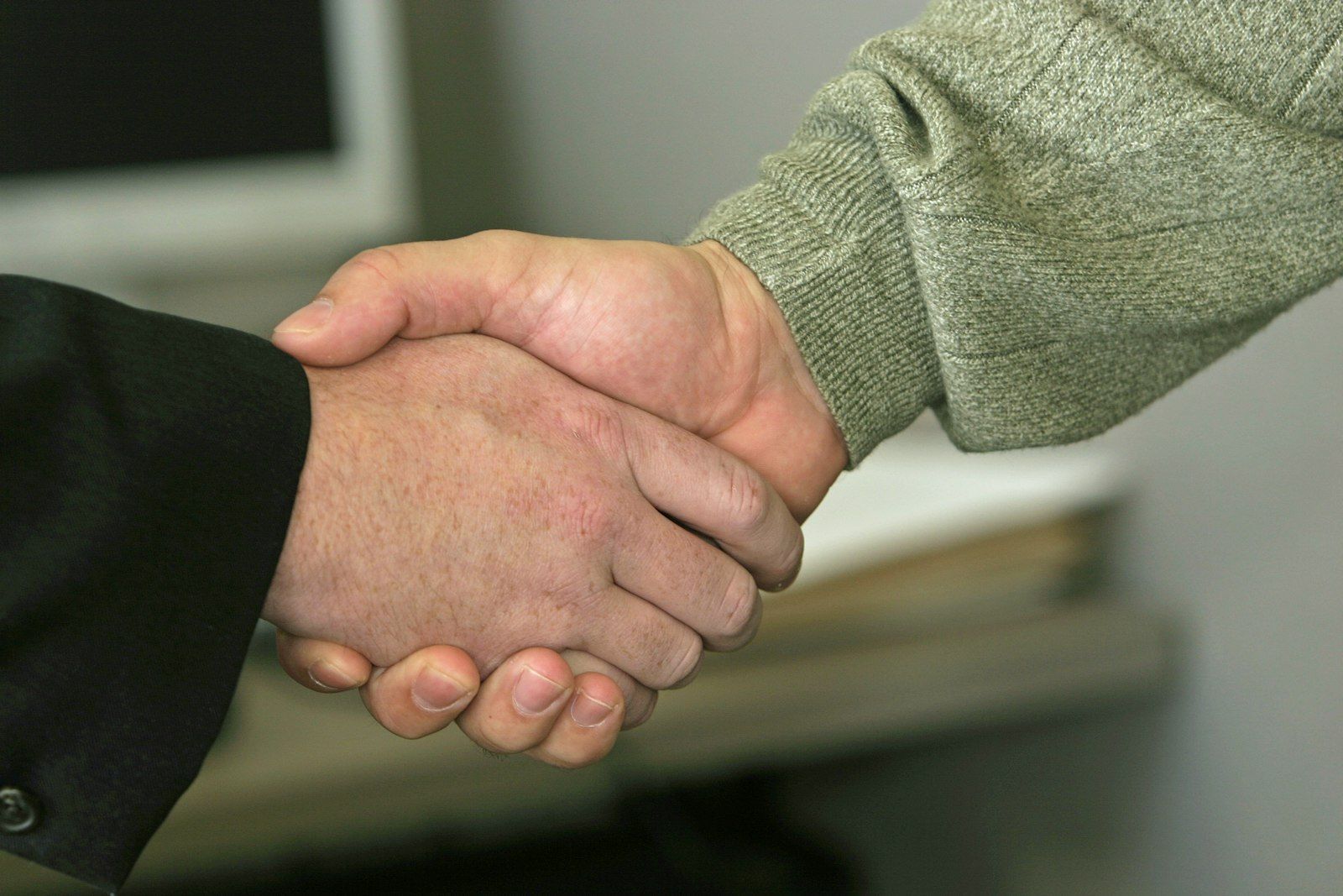 Close-up of two people shaking hands.