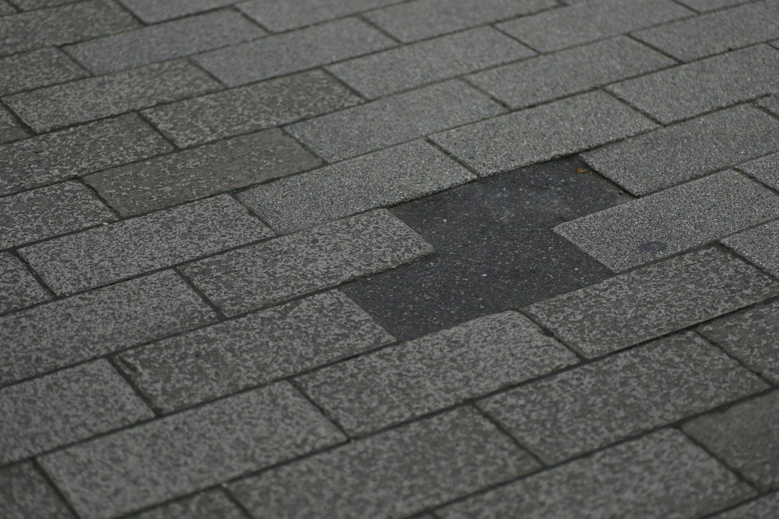 Asphalt shingle roof with missing shingles.