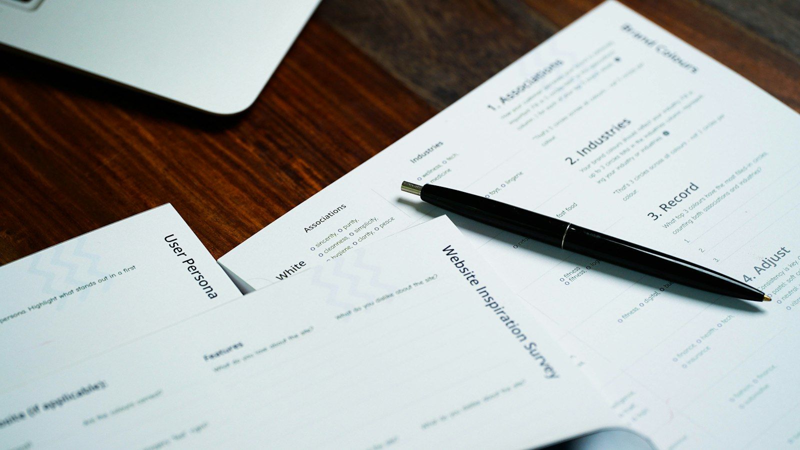 Pen resting on a pile of papers.